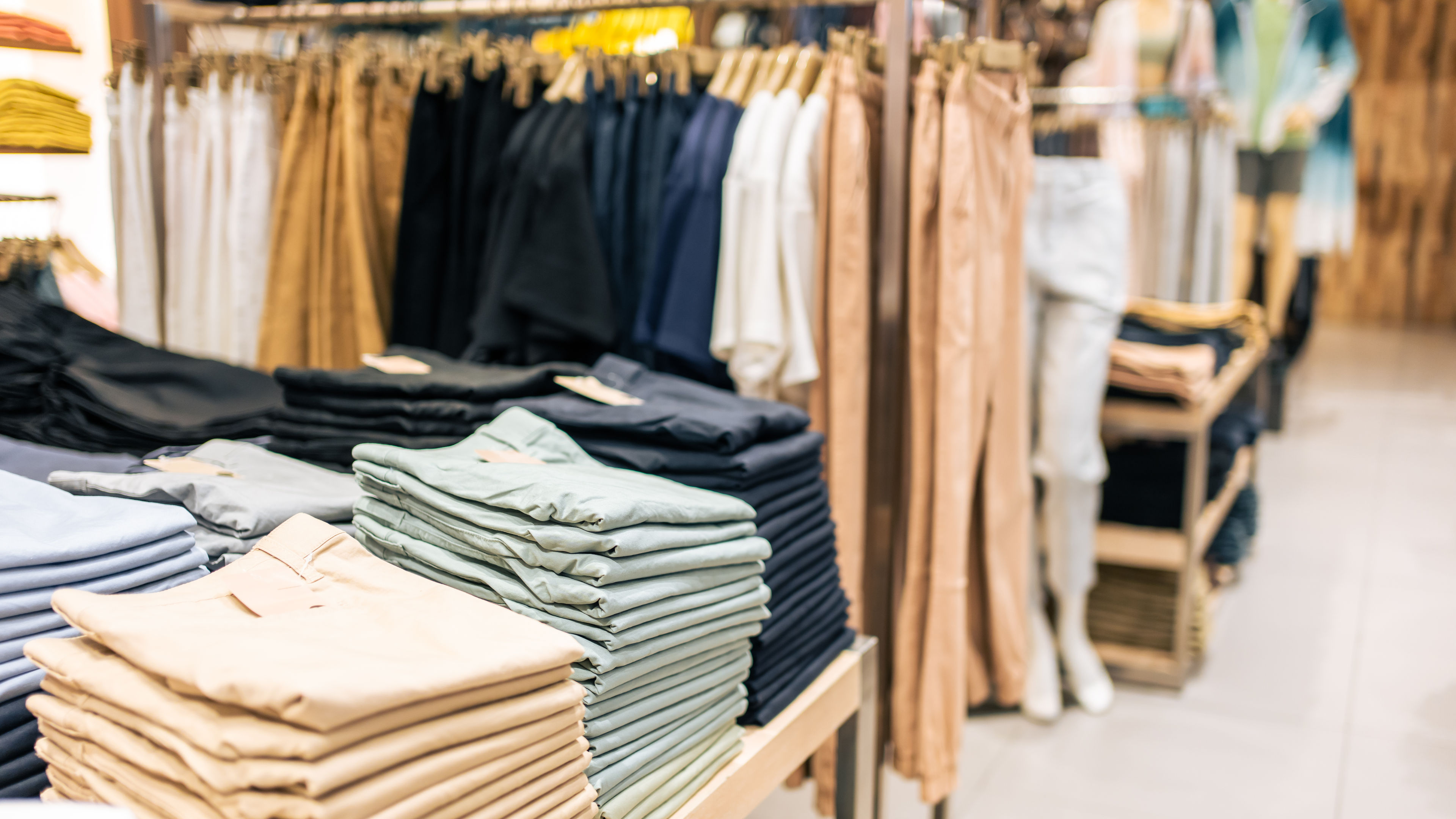 Modern clothing store interior with stylish displays and racks.