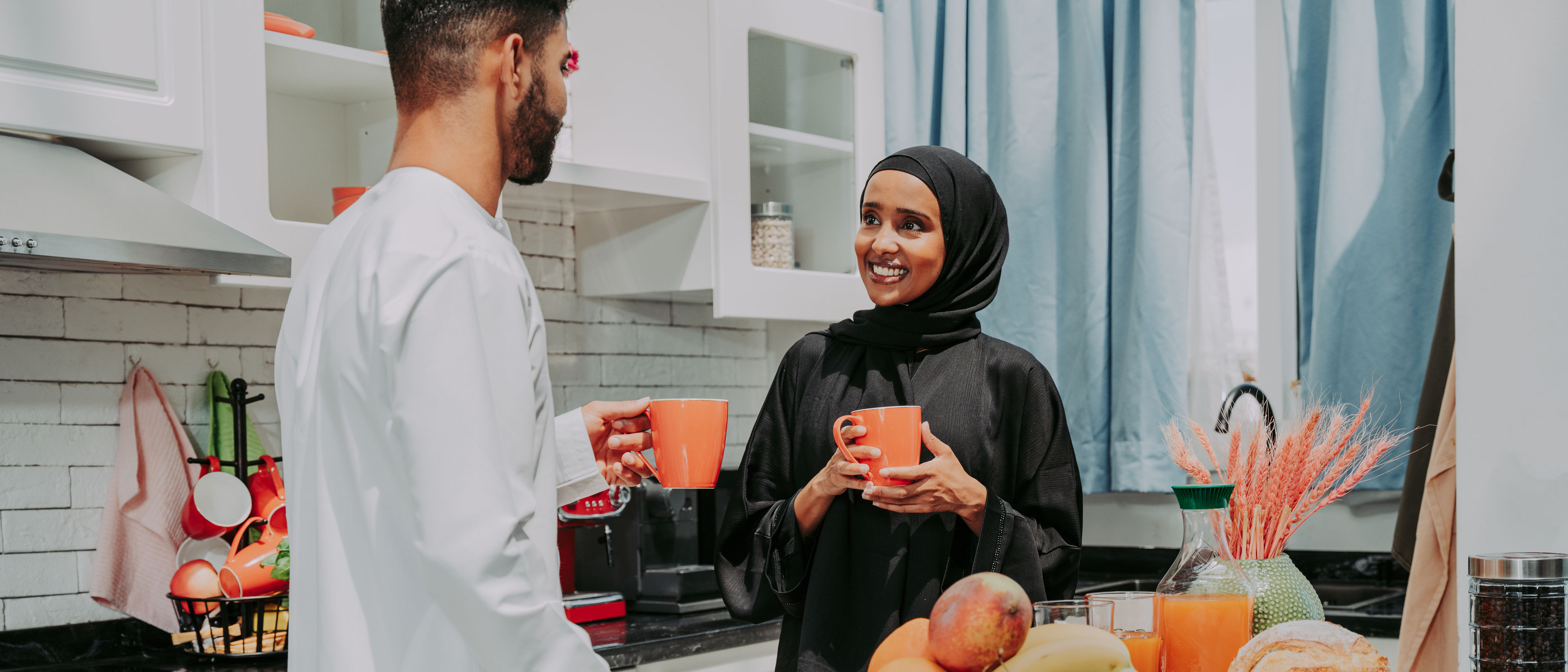 Happy couple at home having coffee